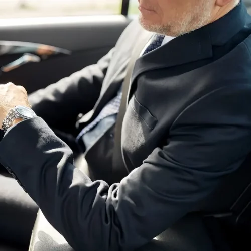 senior businessman driving on car back seat transport, business trip, safety and people concept - senior businessman driving on car back seat
